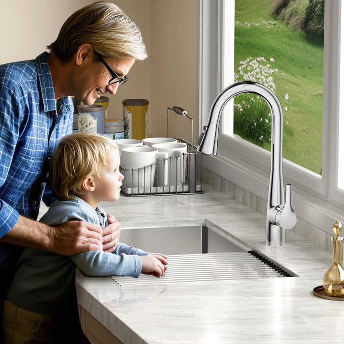 A sleek JOMOO pull-down faucet in brushed stainless steel arcs gracefully over a pristine white sink, its streamlined spout ready for flexible cleaning.