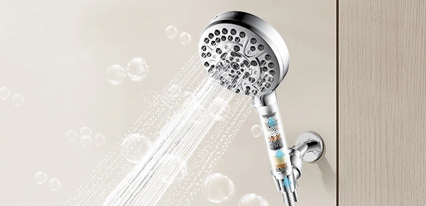 A chrome-finished JOMOO handheld shower head with three spray modes rests on its sleek wall-mounted bracket against white subway tiles.
